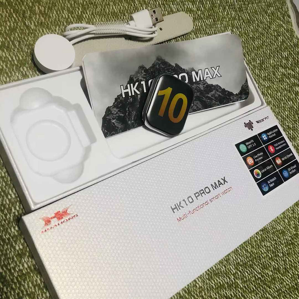 HK10 Pro Max smartwatch packaging with watch, cable, and accessories on a grassy background